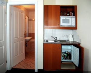 4 person deluxe 3 room suite with city view, king bed, and private facilities (bath and shower)